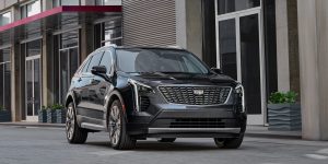 A black 2022 Cadillac XT4 parked outside a shopping center.