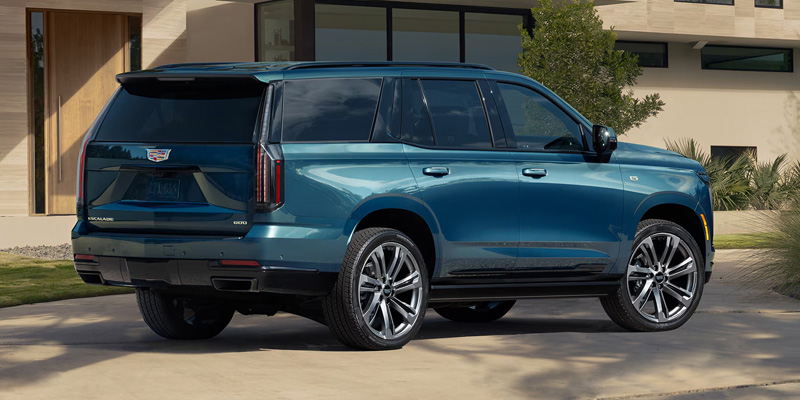 Cadillac Escalade driving on highway showcasing smooth performance.